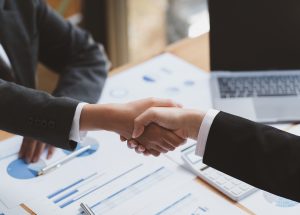 Images of business owners shaking hands forming a partnerships