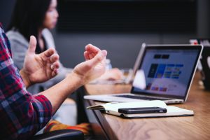 Man discussing ideas with his coworkers