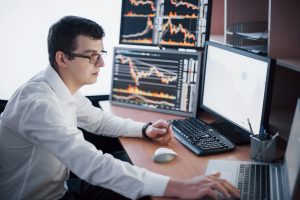 Man monitoring forex trading and stocks 